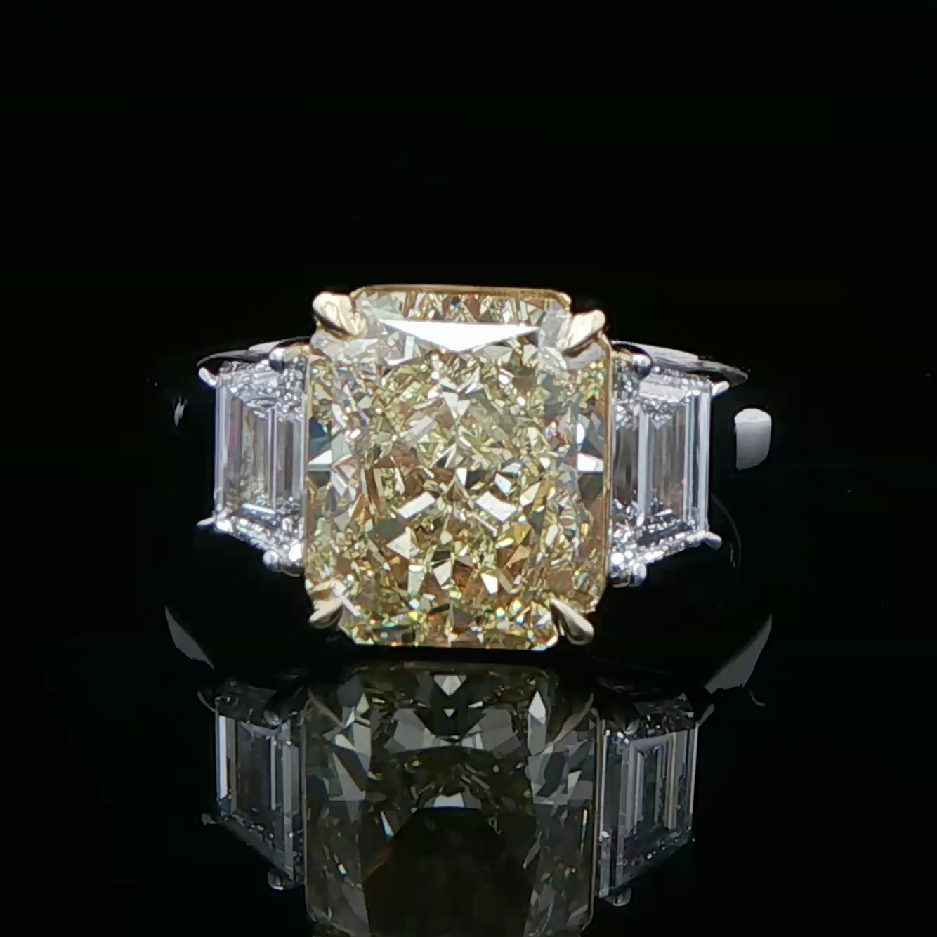 Fancy intense yellow diamond three stone ring in white gold