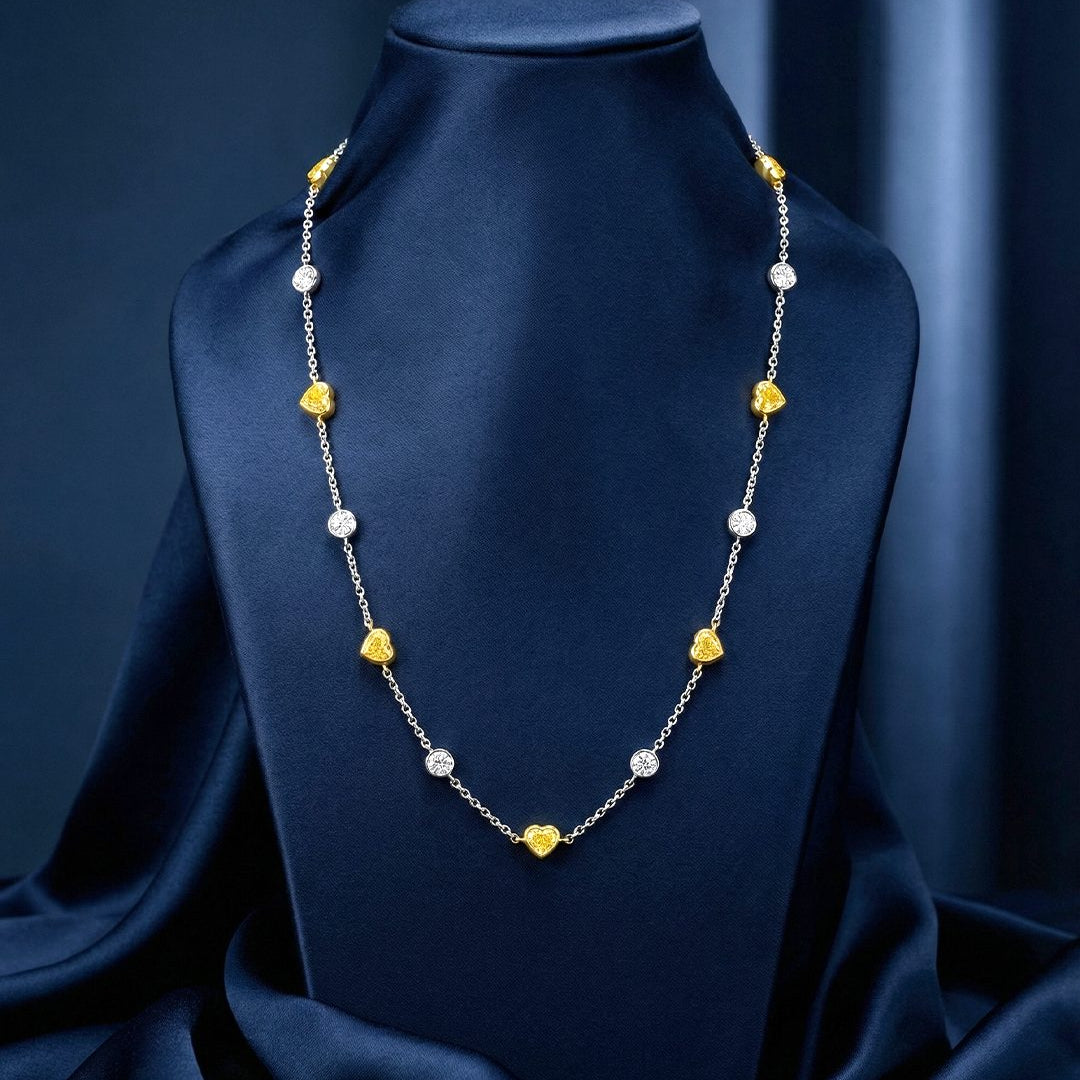 5.82 CT Heart Shape Fancy Yellow Diamond and Round Brilliant Diamond Necklace in 18K White Gold and Yellow Gold, worn on model, view 1 - fine jewelry in San Francisco
