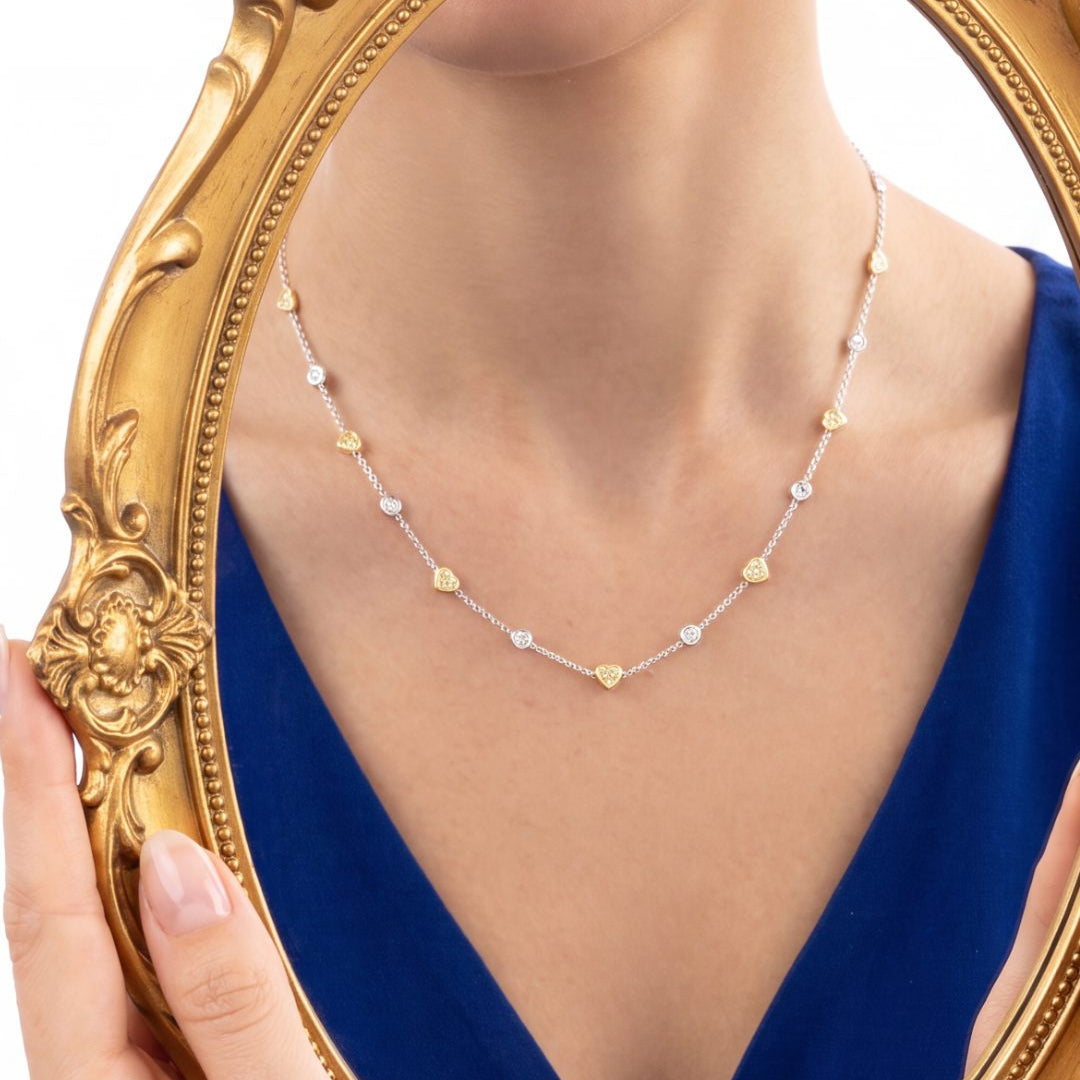 5.82 CT Heart Shape Fancy Yellow Diamond and Round Brilliant Diamond Necklace in 18K White Gold and Yellow Gold, worn on model, view 2 - fine jewelry in San Francisco