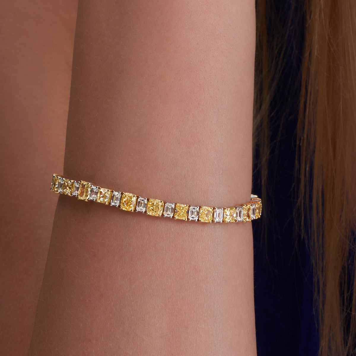 16.35 CTW. Fancy Yellow Diamond and Emerald Cut Diamond Bracelet in 18K White and Yellow Gold - worn on model