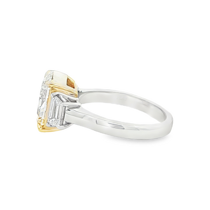 Fancy intense yellow diamond ring with step cut side diamonds
