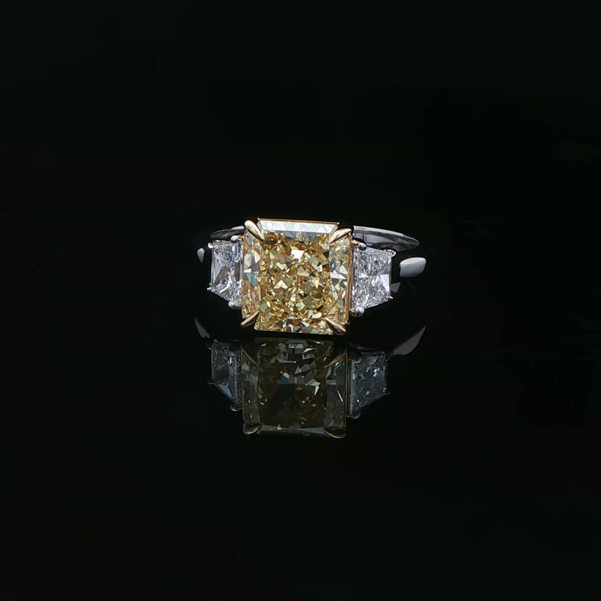 Fancy intense yellow diamond three stone ring in white gold