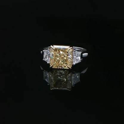 Fancy intense yellow diamond three stone ring in white gold