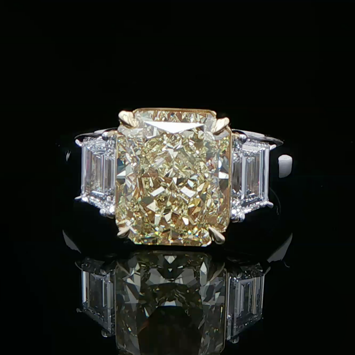 Fancy intense yellow diamond three stone ring in white gold
