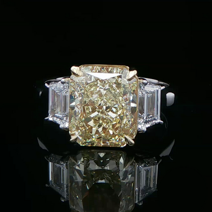Fancy intense yellow diamond three stone ring in white gold