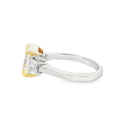 Fancy intense yellow diamond ring with trapezoid cut side diamonds