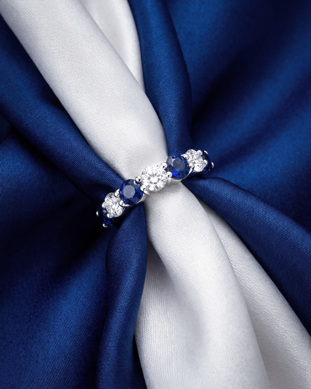 2.9 CT Alternating Round Brilliant Blue Sapphire and Diamond Halfway Ring in Platinum, worn on model, view 1 - fine jewelry in San Francisco