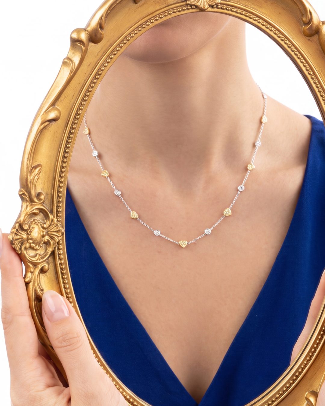 5.82 CT Heart Shape Fancy Yellow Diamond and Round Brilliant Diamond Necklace in 18K White Gold and Yellow Gold, worn on model, view 2 - fine jewelry in San Francisco