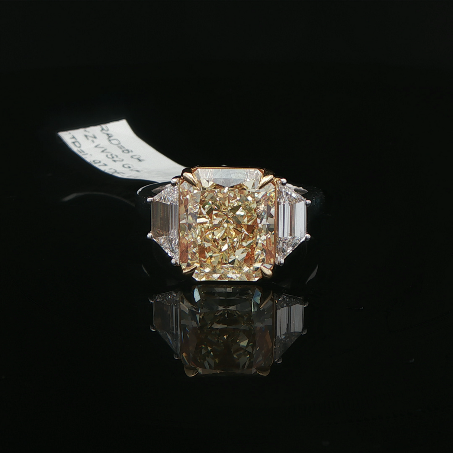 Yellow diamond three stone ring close up