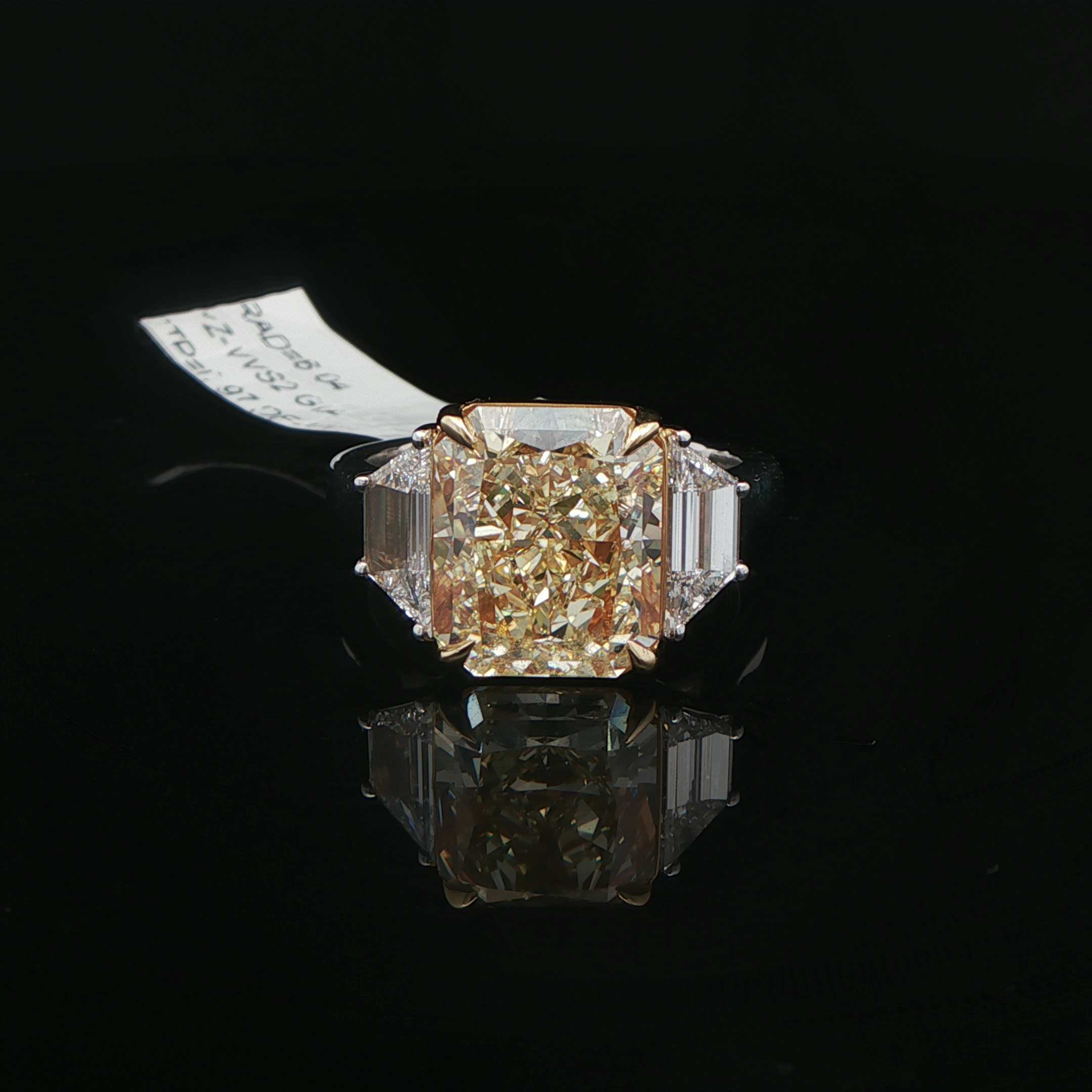 Yellow diamond three stone ring close up