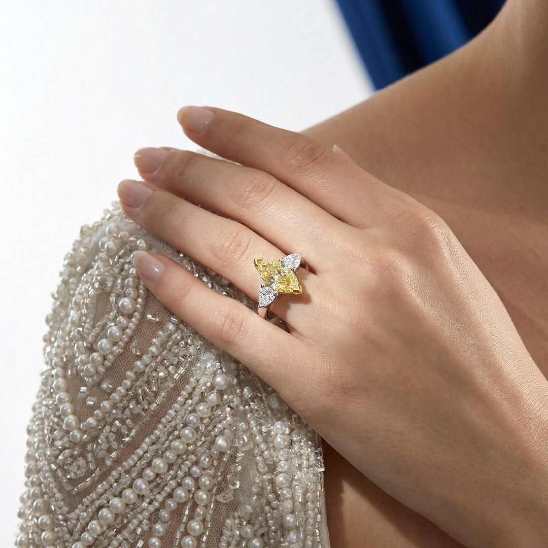 2.46 CT Three Stone Ring with Fancy Light Yellow Marquise and Pear Diamonds in 18K Yellow Gold and Platinum, worn on model, view 1 - fine jewelry in San Francisco