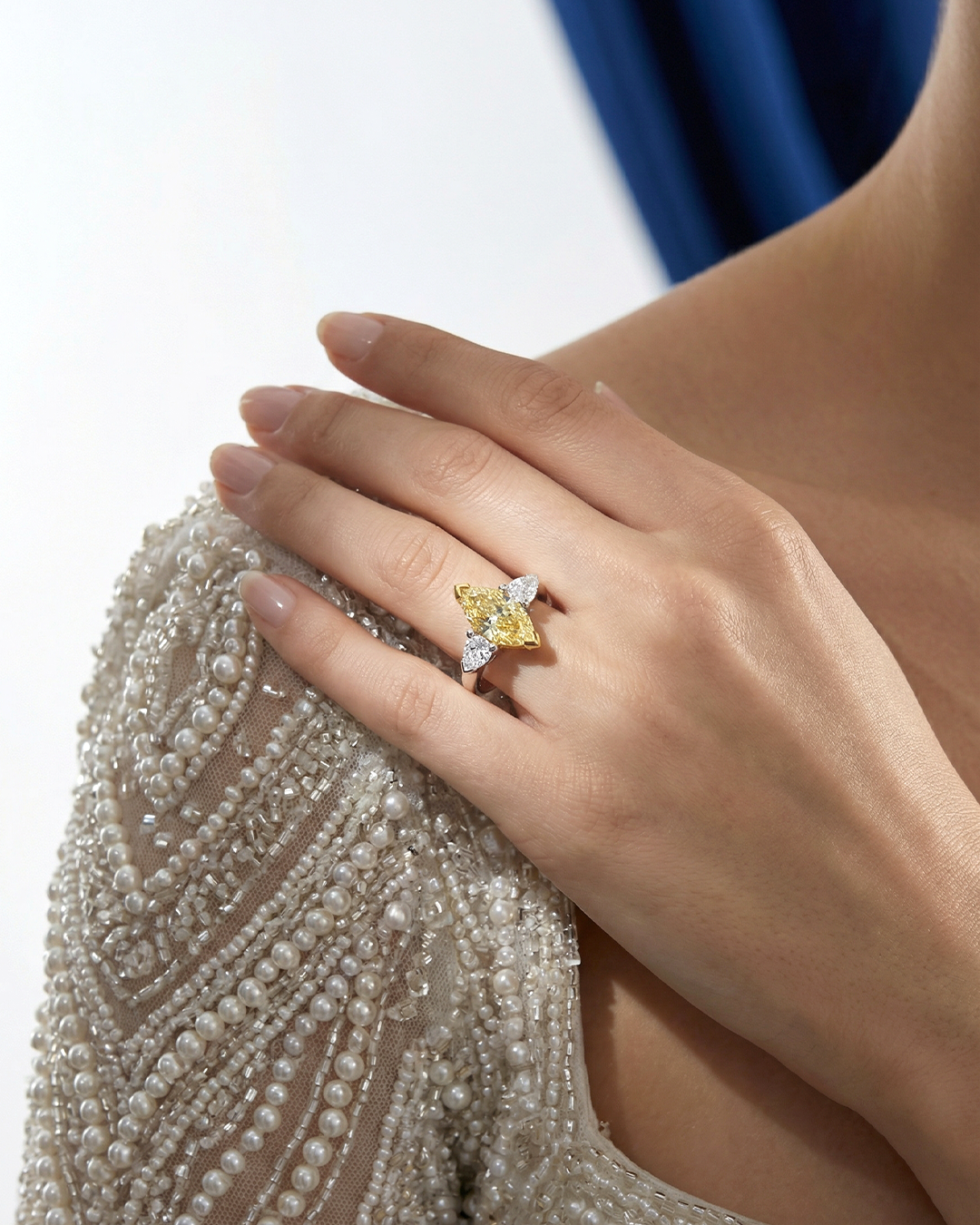 2.46 CT Three Stone Ring with Fancy Light Yellow Marquise and Pear Diamonds in 18K Yellow Gold and Platinum, worn on model, view 1 - fine jewelry in San Francisco